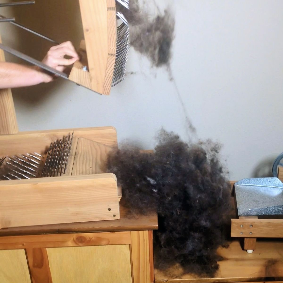 image of a swing picker in action with wool fluff next to is showing picked wool View this post on Instagram A post shared by Petalworks Farm (@petalworksfarm)DIY swing picker opening washed wool before carding