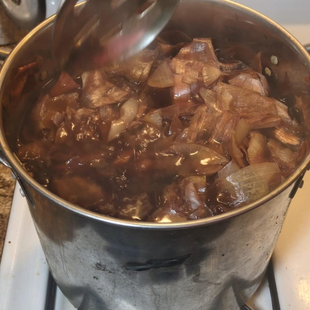 Golden onion-skin dye bath simmering on the stove.