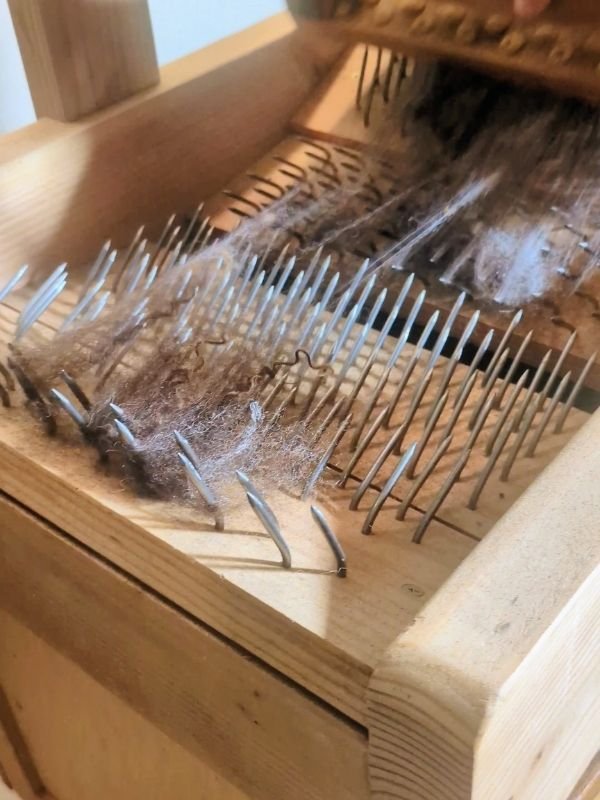 a swing picker showing how it opens up wool fibers