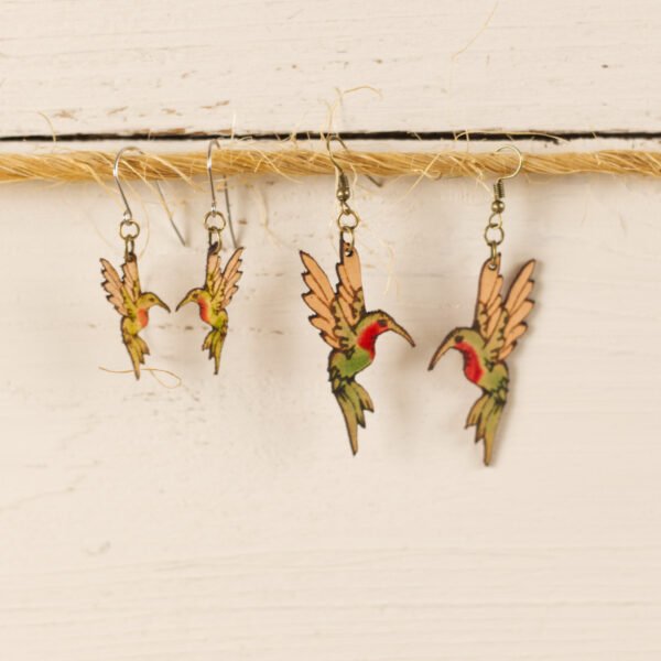 small and large leather hummingbird earrings hanging on a piece of twine to display the size difference