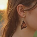 woman wearing a beautiful monarch butterfly leather earring.