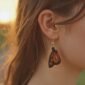 woman wearing a beautiful monarch butterfly leather earring.