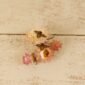 tiny leather bee stud earrings on a flower